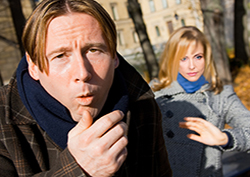 Woman afraid of exposure to whooping cough, man coughing near her